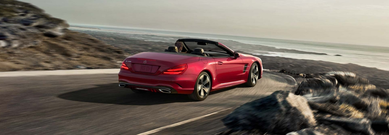 2019 Mercedes-Benz SL Roadster in red rounding a corner on a coastal road